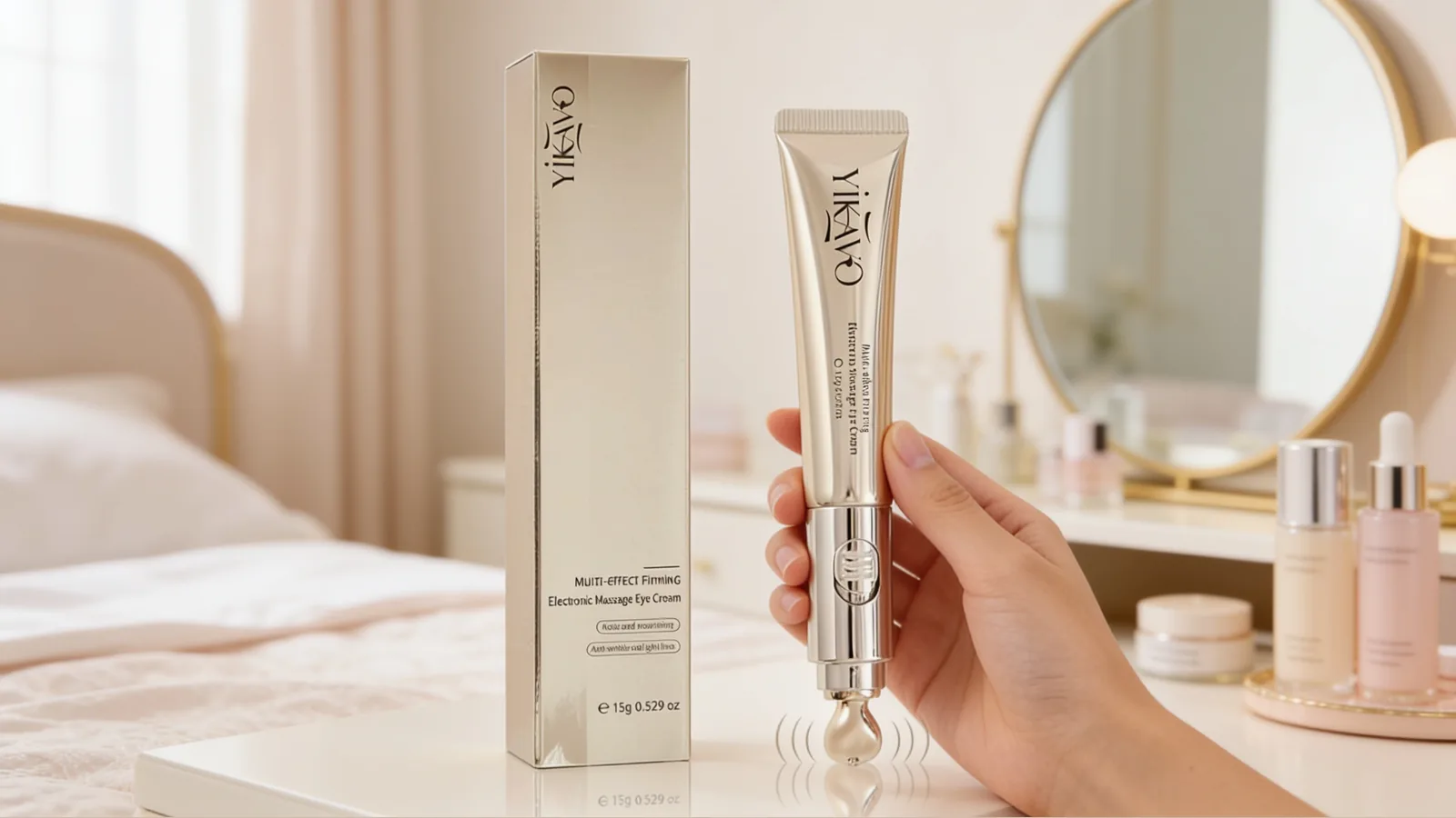 Yikavo eye cream applicator and matching box shown in a bedroom vanity scene, with a hand holding the tube and a visible massage tip emitting subtle vibration lines.